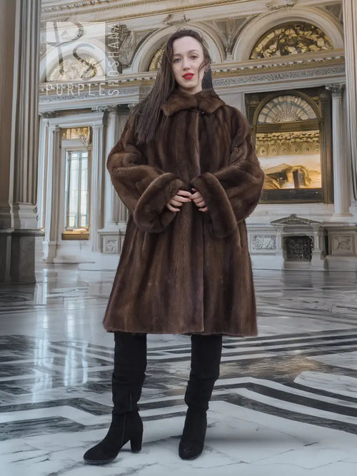 Brown mink fur coat with structured shoulders, wide cuffs, and full swing hem.