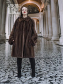 Dark brown fur hooded coat with side pockets and A-line swing shape.