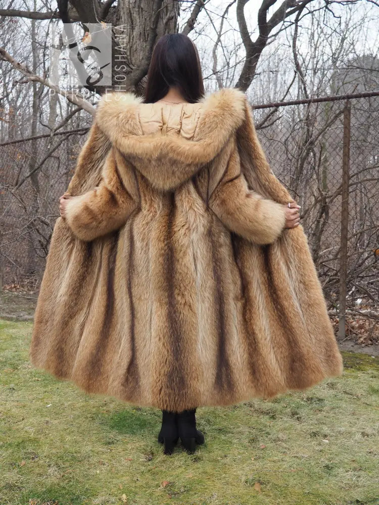 Tanuki raccoon fur coat showing back hood and flared skirt hem, tan fur, full view from behind.