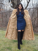 Tanuki raccoon fur coat with hood and open front, tan fur, full-body view with hands at sides.