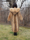 Tanuki raccoon fur coat from behind with hood up, tan fur, relaxed arms at sides.