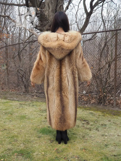 Tanuki raccoon fur coat from behind with hood up, tan fur, relaxed arms at sides.