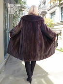 Dark mink fur hooded coat, back view with flared sleeves and full length