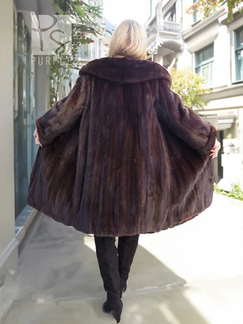 Dark mink fur hooded coat, back view with flared sleeves and full length