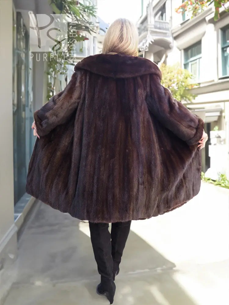 Dark mink fur hooded coat, back view with flared sleeves and full length