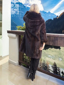Dark mink fur coat with hood, back view showing draped shoulder texture