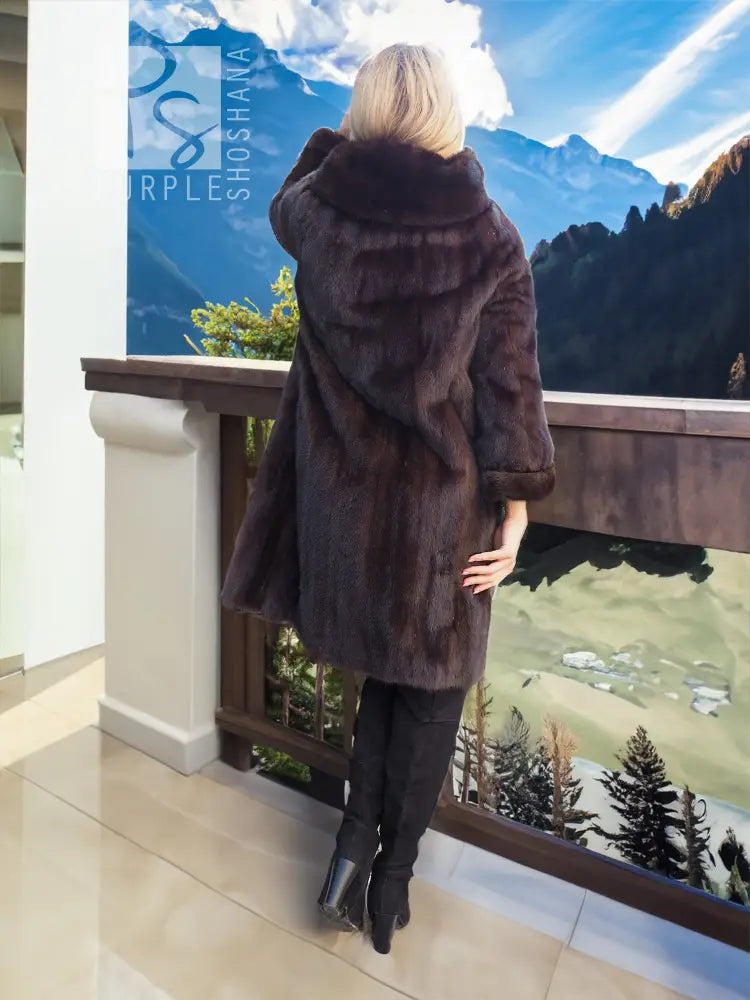 Dark mink fur coat with hood, back view showing draped shoulder texture