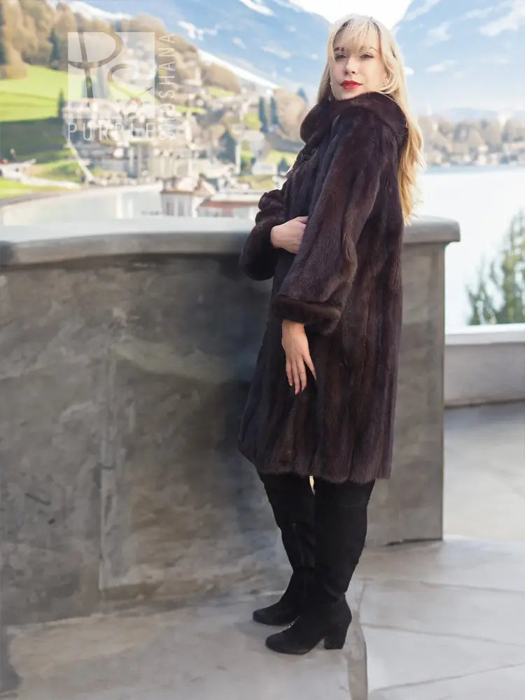 Dark mink fur coat with hood and long sleeves, tailored fit over boots