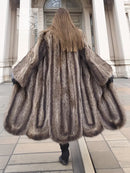 Back view of dark brown raccoon fur coat with gathered scalloped hem and full skirt