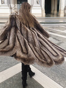 Back view of raccoon fur coat with scalloped hem, long shag texture