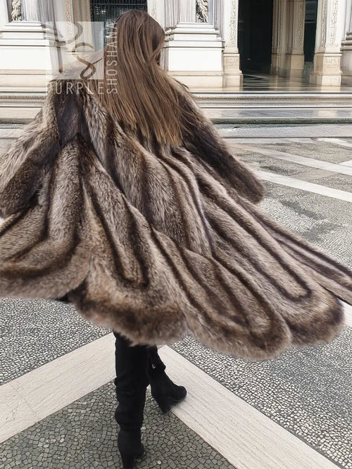 Back view of raccoon fur coat with scalloped hem, long shag texture