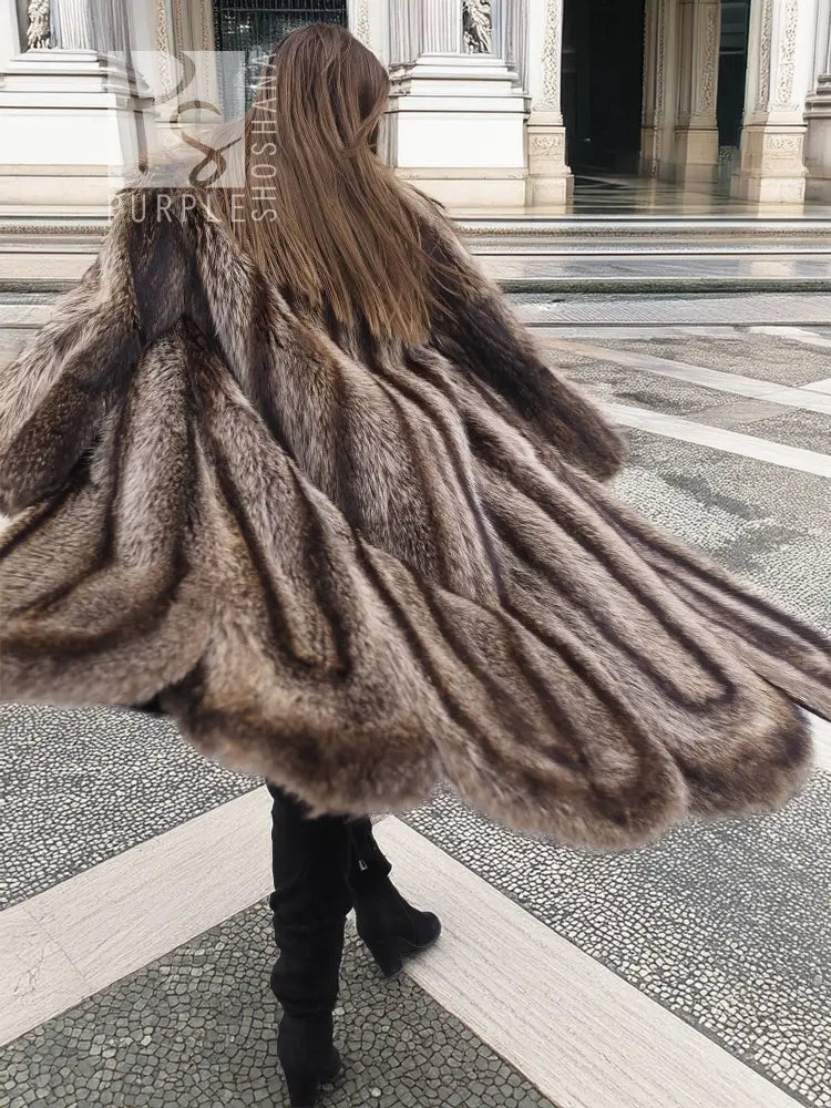 Back view of raccoon fur coat with scalloped hem, long shag texture