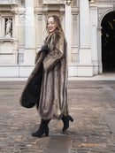 Dark brown fur coat with long sleeves, scalloped hem, and button-front closure