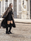 Raccoon fur coat with scalloped hem, open front showing black mini dress
