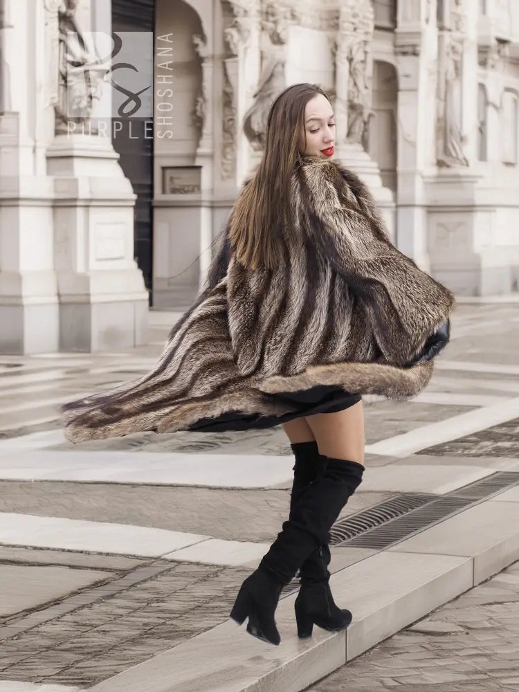 Dark brown fur coat with scalloped hem and long sleeves, flowing fringe detail