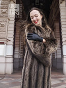 Raccoon fur coat with dark collar, long sleeves, and black leather gloves