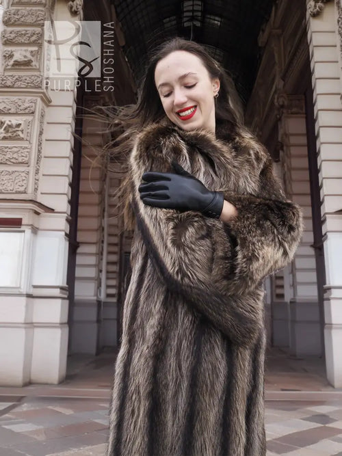 Raccoon fur coat with dark collar, long sleeves, and black leather gloves
