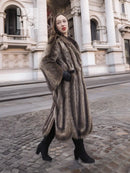 Raccoon fur coat in dark brown with flared hem and open front, side view