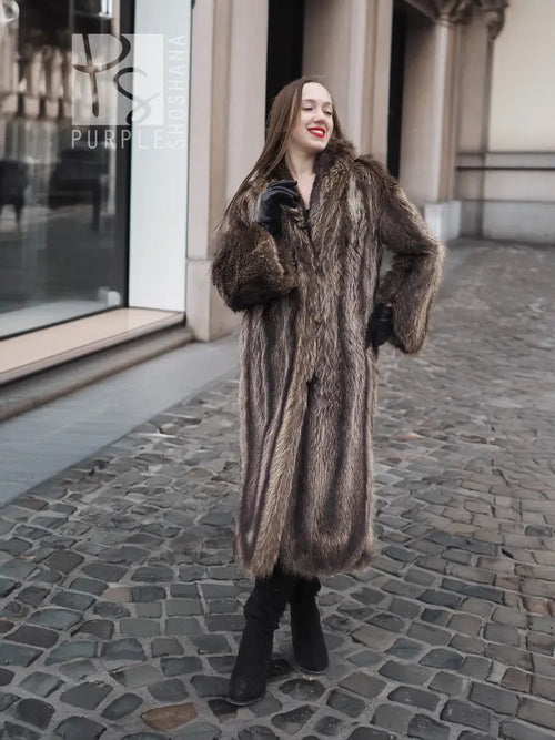 Long dark brown raccoon fur coat with open front and fitted sleeves, standing pose