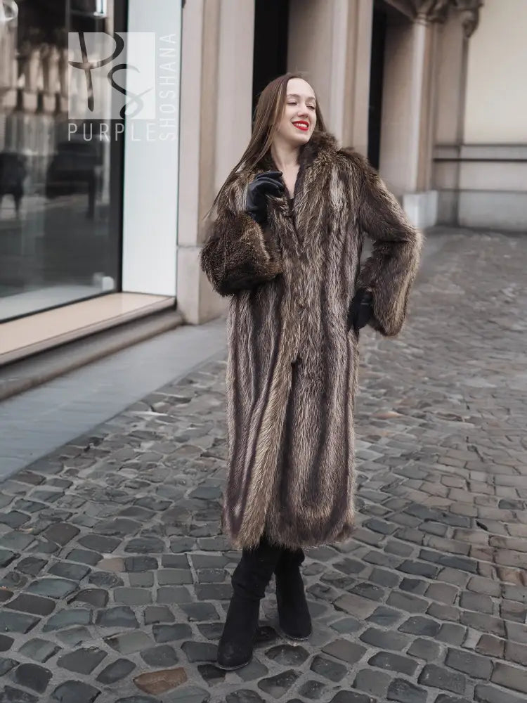Long dark brown raccoon fur coat with open front and fitted sleeves, standing pose