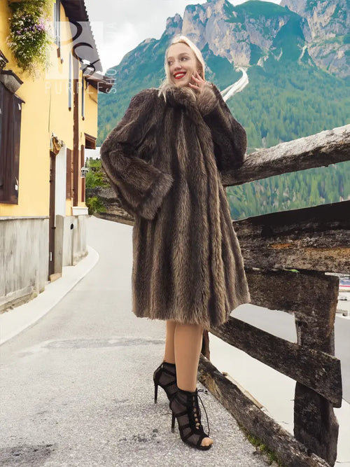 Dark fur coat with attached hood, long sleeves and flared mid-calf hem