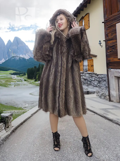Dark brown fur coat with attached hood, long sleeves and flared hem with slit