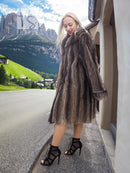 Dark brown fur hooded coat with side slit hem and long flared sleeves