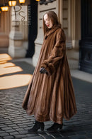 Brown mink fur coat with large collar, long sleeves, and flared full skirt