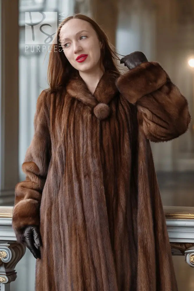 Brown mink fur coat close-up with rounded collar and fuzzy sleeve cuffs