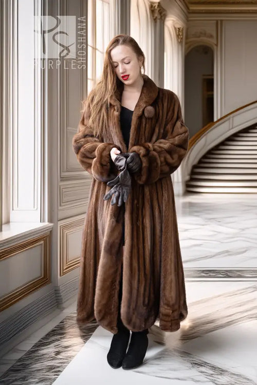 Brown mink fur full-length coat with buttoned front, wide collar, and textured cuffs