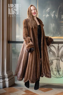 Brown mink fur coat with long sleeves and buttoned front, standing pose