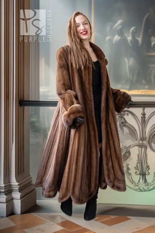 Brown mink fur coat with long sleeves and buttoned front, standing pose