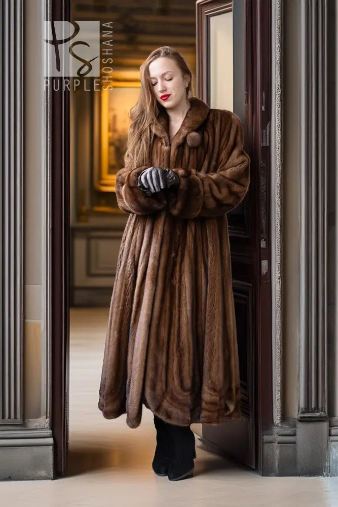 Brown full-length mink fur coat with structured collar and rounded sleeve cuffs