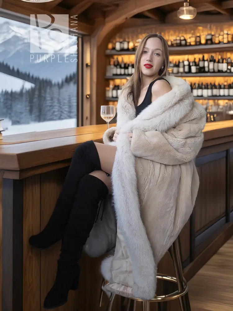 Sheared beaver fur coat with fox trim, light champagne, seated holding a glass