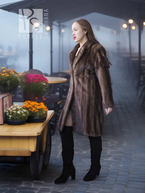 Mink fur coat in dark brown with long sleeves and open front, side view outdoors