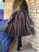 Back view of dark brown faux mink fur coat with flared shoulders and hem