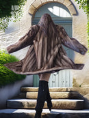 Back view of dark brown faux mink fur coat with wide, flared shape