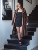 Mink fur coat with stand collar, flared midi shape, brown, worn over black mini dress