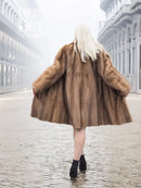 Pastel brown mink fur coat with hood, flared skirt, elbow-to-mid thigh length