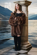 Brown mink fur jacket with oversized plush fur collar and long straight silhouette