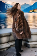 Brown mink fur jacket with rich brown fur, side profile pose on balcony