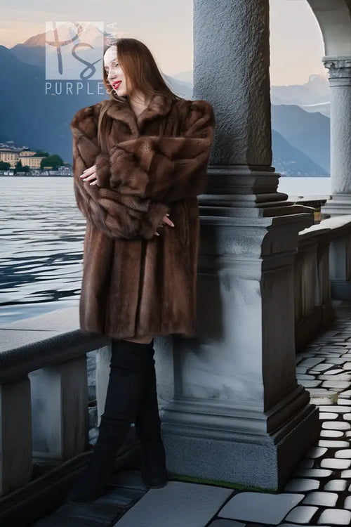 Brown mink fur jacket with plush collar and vertical fur panels, arms crossed