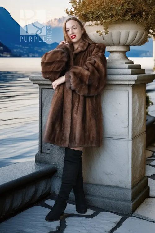 Brown mink fur jacket with full-length buttonless front and voluminous fur sleeves
