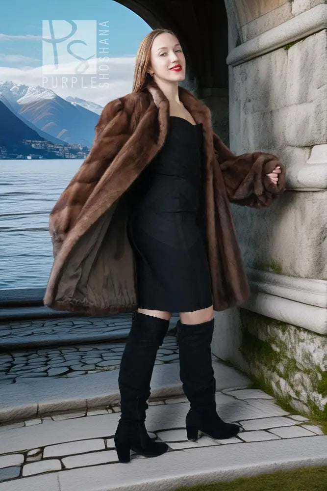 Brown mink fur jacket draped over black dress with wide collar and long sleeves