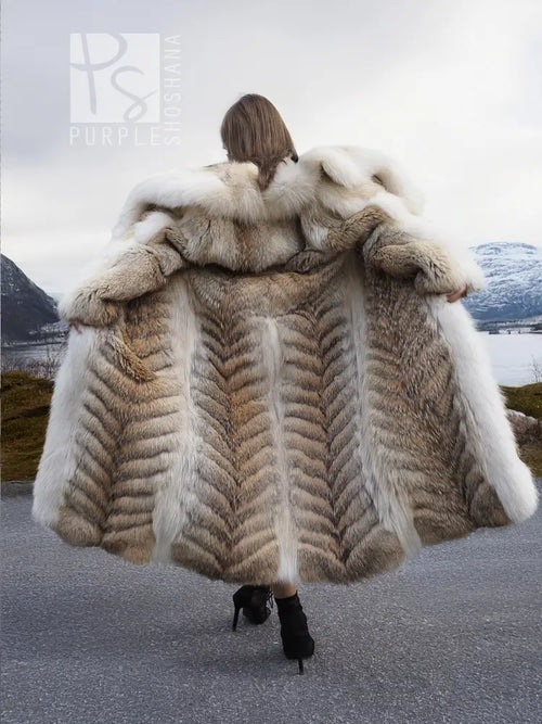 Back view of coyote fur coat with white fox trim and shawl collar, long flared hem