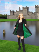 Dark green beaver jacket front with open drape and wide collar, worn over black dress