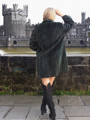 Dark sheared beaver jacket from back view, long sleeves and straight A-line cut.