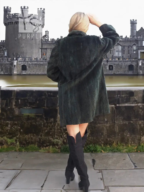 Dark sheared beaver jacket from back view, long sleeves and straight A-line cut.