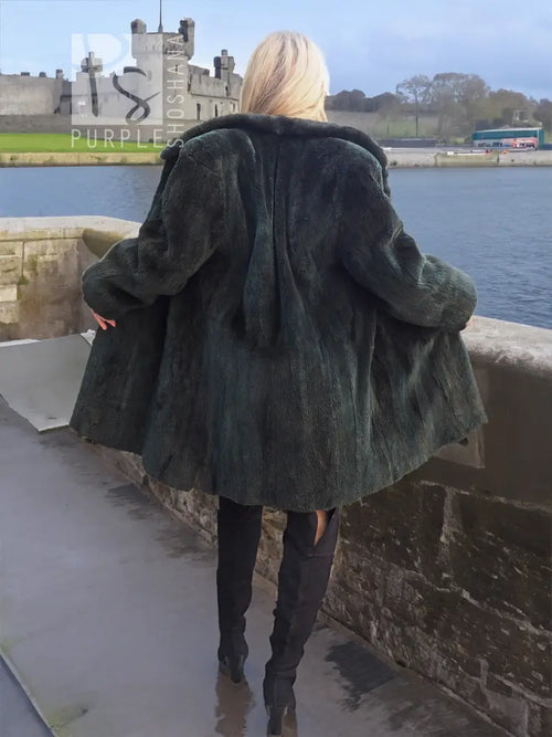 Dark green beaver jacket, back view, voluminous shoulders and long sleeves.