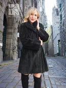 Dark sheared beaver jacket with long sleeves, stand collar, and draped front.